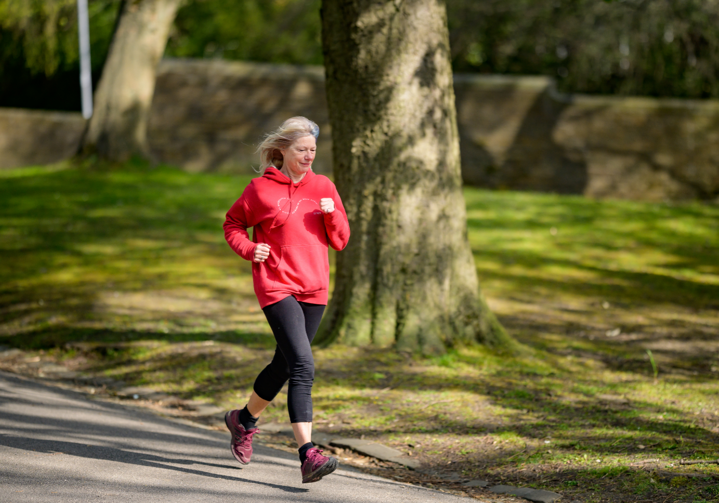 Woman with red top running in park
